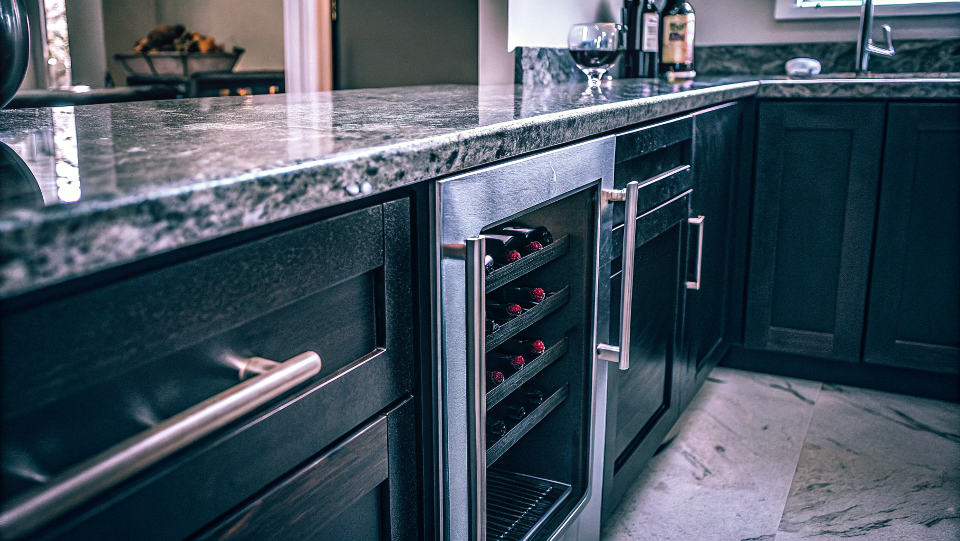A stylish built-in wine cooler integrated into an office kitchen island.