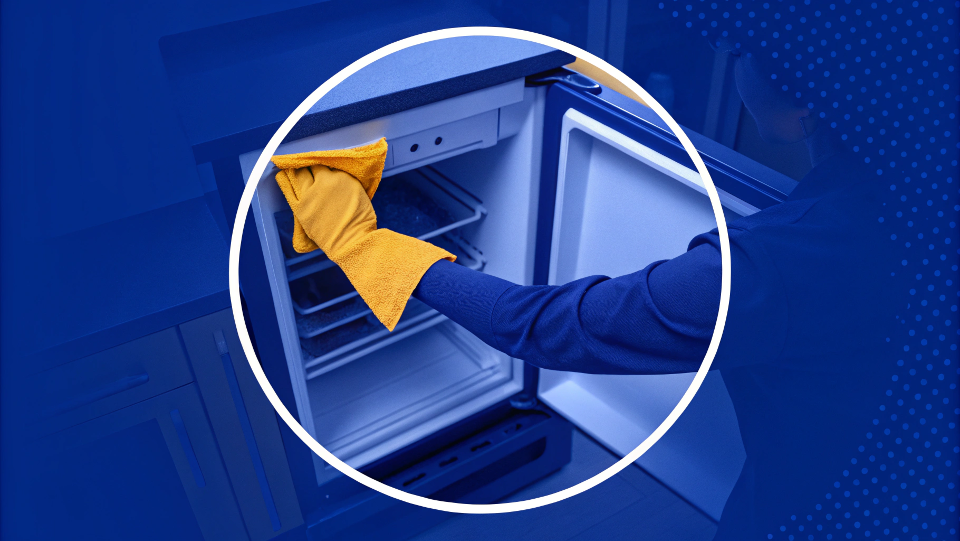 a close-up of a person cleaning a refrigerator door seal with a cloth