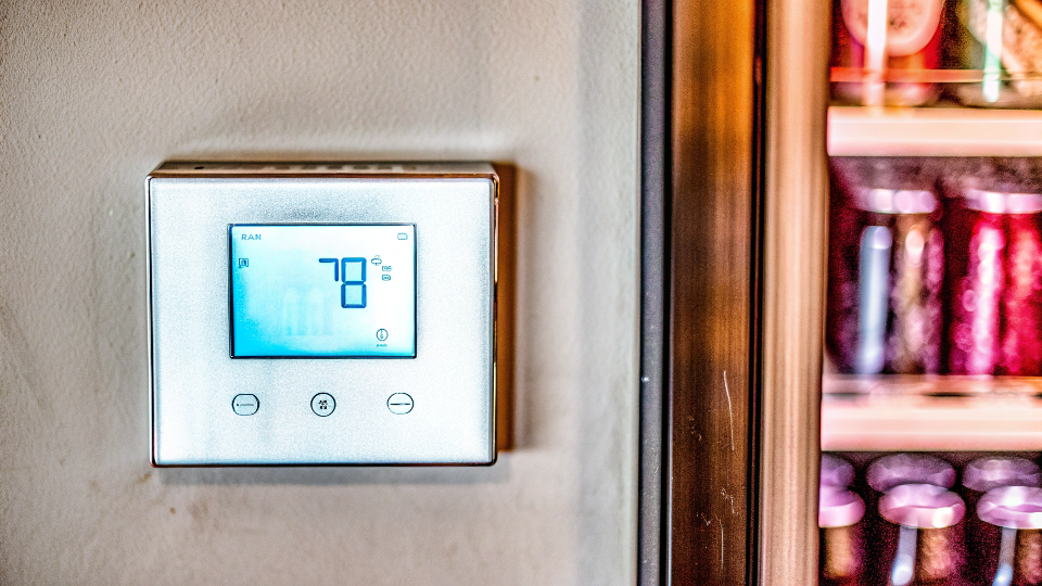 A digital thermostat on a beverage cooler showing the temperature