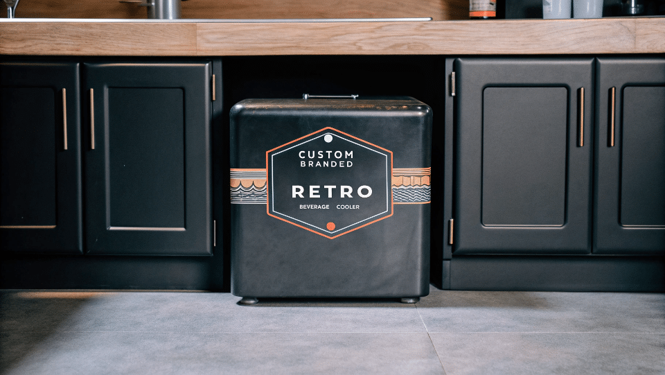 A custom-branded retro beverage cooler in a stylish kitchen setting.