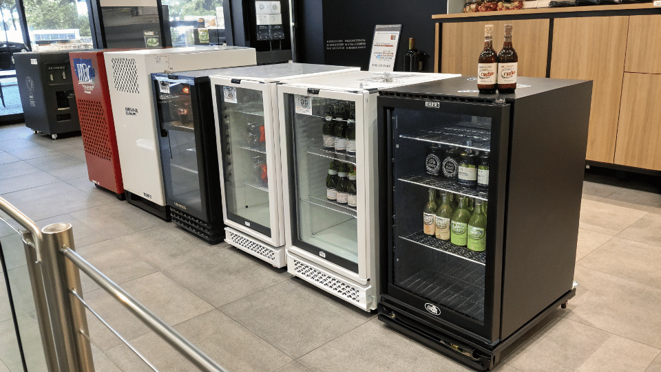 A collection of stylish, modern compact bar coolers in a showroom.