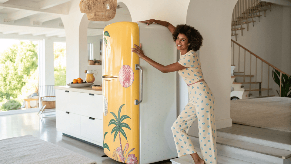 influencer posing with a retro fridge for social media