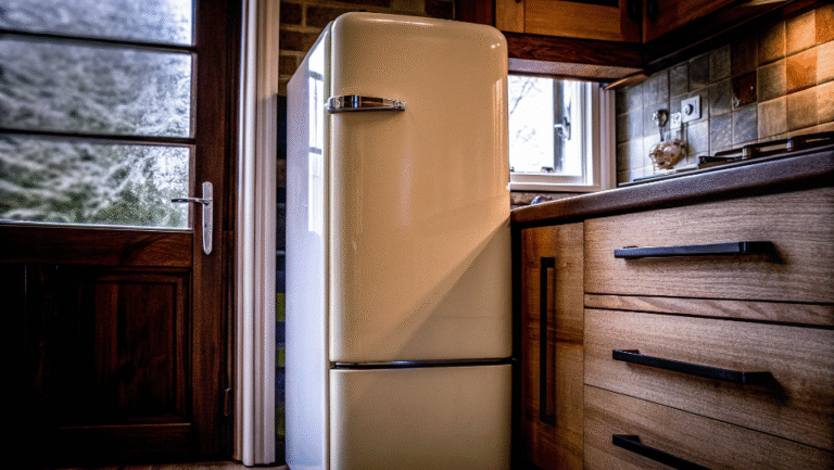 A stylish, cream-colored retro refrigerator in a modern kitchen