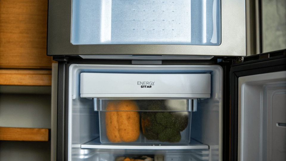 A modern top-freezer refrigerator with an Energy Star label on it