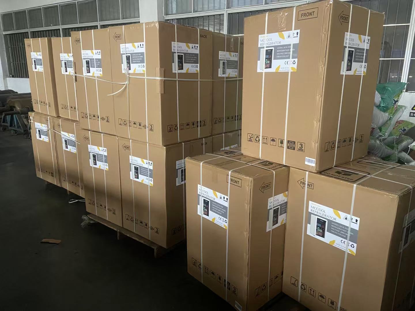 A warehouse with stacked boxes of refrigerators, ready for shipping
